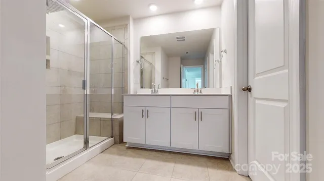 a bathroom with a tub shower and sink