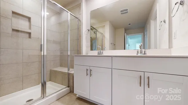 a bathroom with a shower and a sink