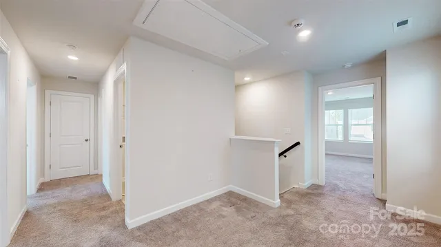 an empty room with windows and entrance