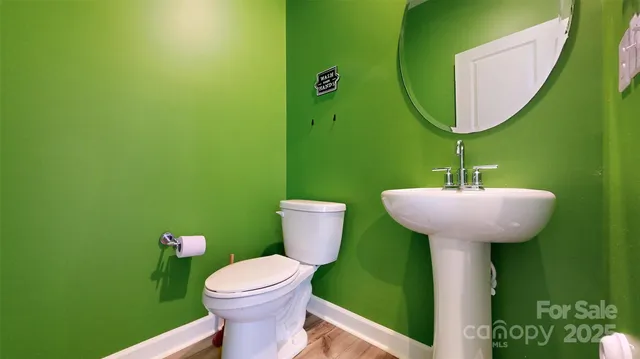 a bathroom with a sink mirror and toilet