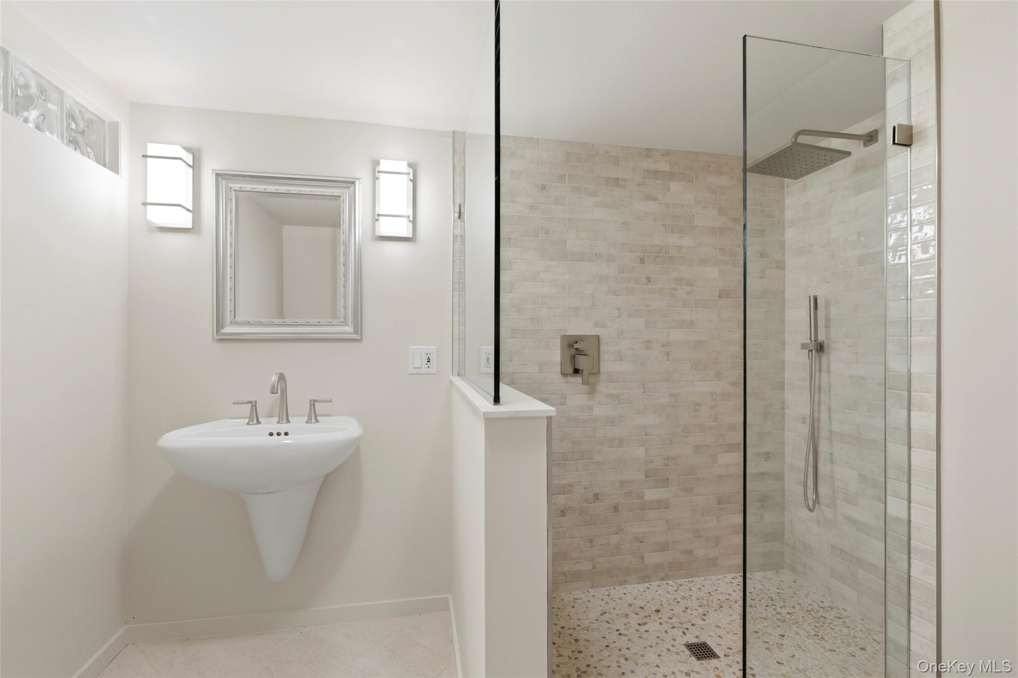 7 Gun Path Setauket, NY 11733 - Photo 29 of 34 a bathroom with a sink a mirror and shower