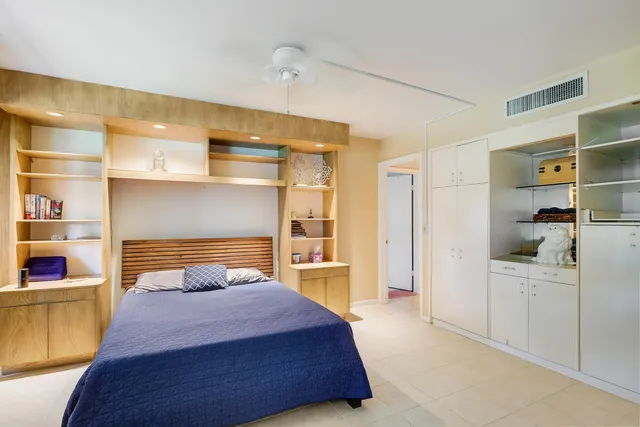 a bedroom with a bed and a cabinets