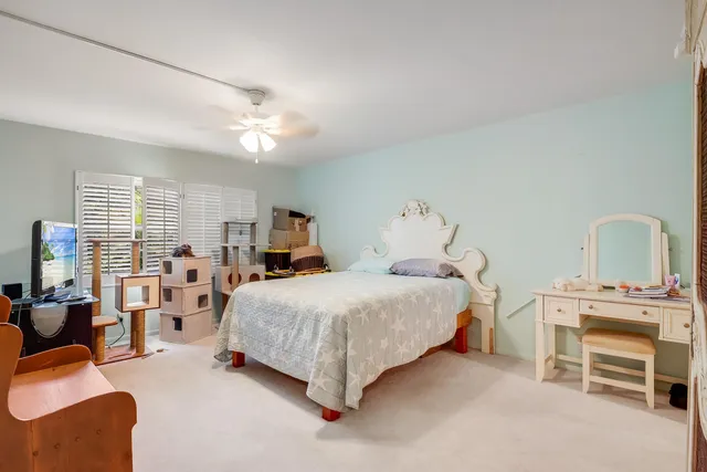 a bedroom with bed and a chandelier
