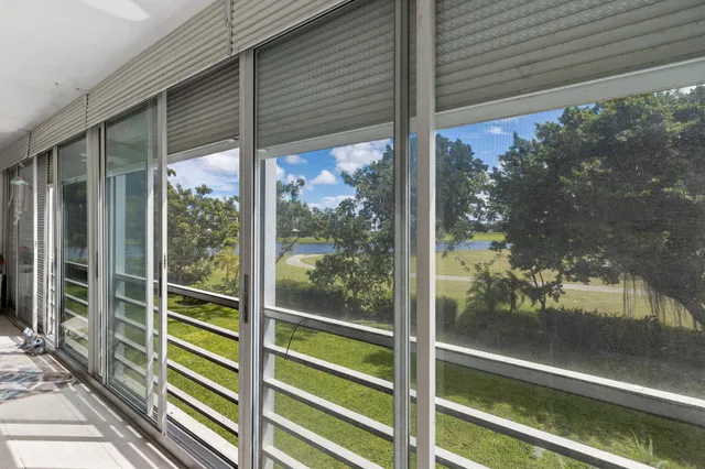 a view of a glass door with a tree