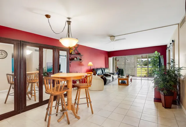 a dining room with furniture window and outside view