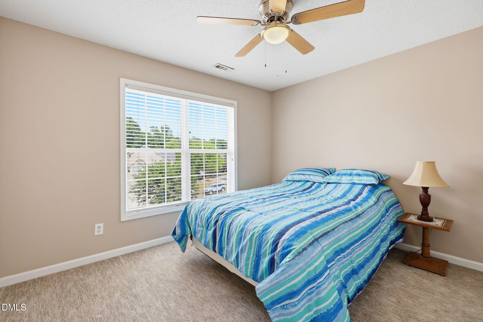 9105 Willow Valley Court Raleigh, NC 27617 - Photo 25 of 51 a bedroom with a bed and a chandelier