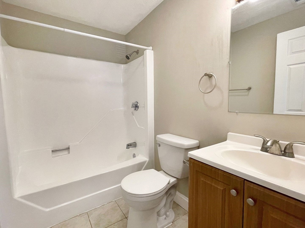 1617 Braley Road, Unit 82 New Bedford, MA 02745 - Photo 11 of 12 a bathroom with a sink toilet and shower