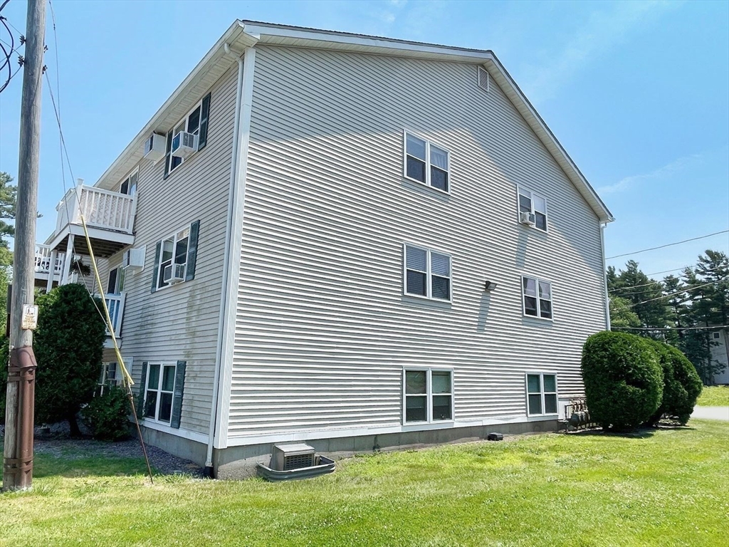 1617 Braley Road, Unit 82 New Bedford, MA 02745 - Photo 3 of 12 a front view of a house with a yard