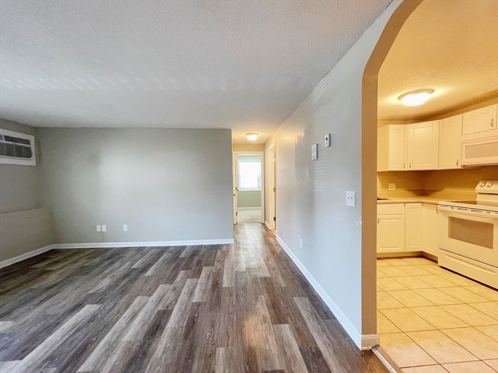 1617 Braley Road, Unit 82 New Bedford, MA 02745 - Photo 4 of 12 a view of a hallway with a wooden floor