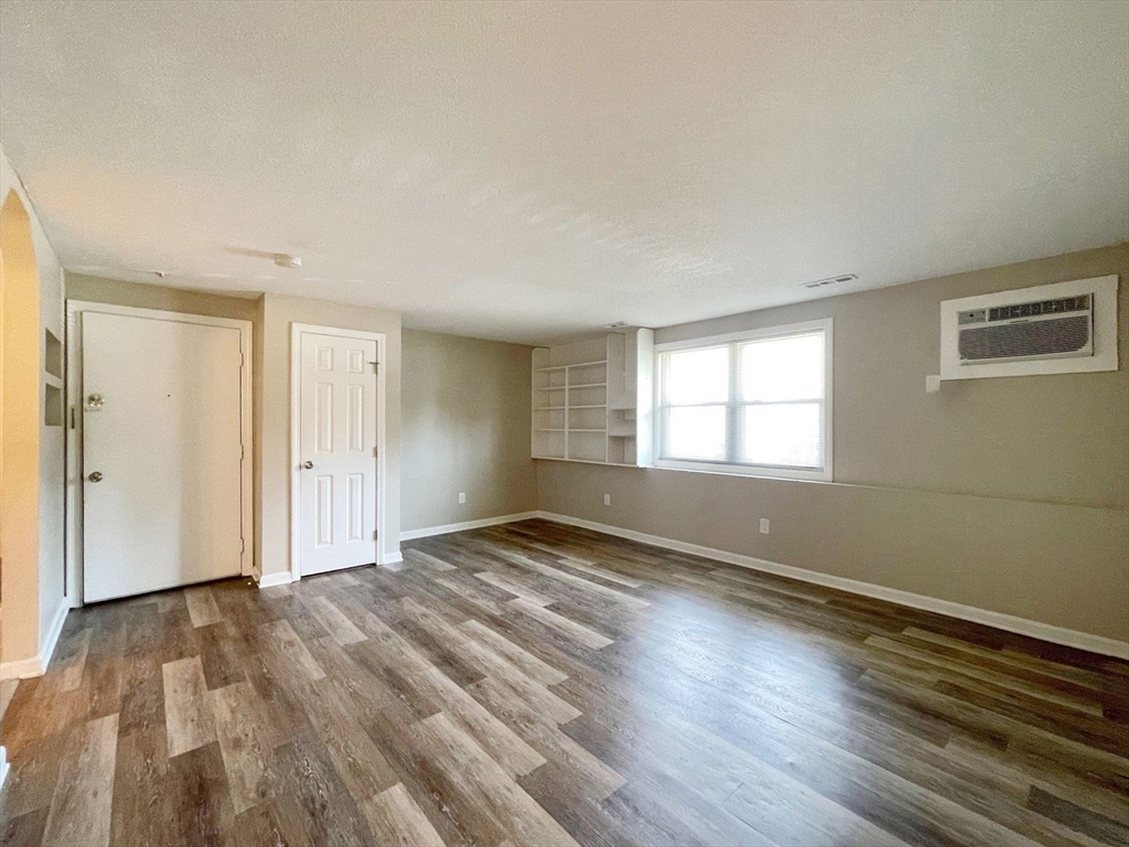 1617 Braley Road, Unit 82 New Bedford, MA 02745 - Photo 6 of 12 a view of empty room with wooden floor and fan