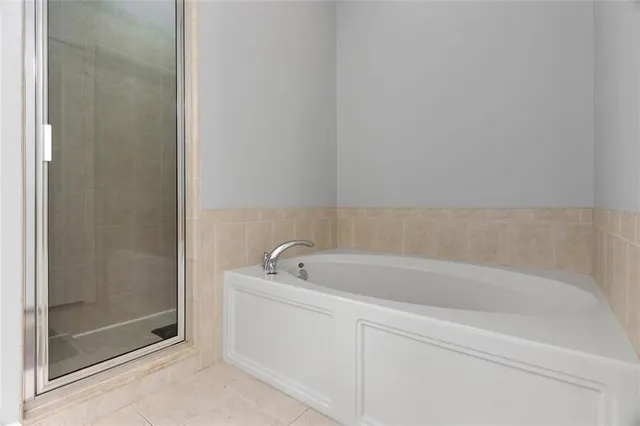 a spacious bathroom with a bathtub and sink