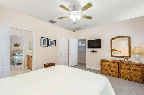 a bedroom with a bed and dresser with mirror