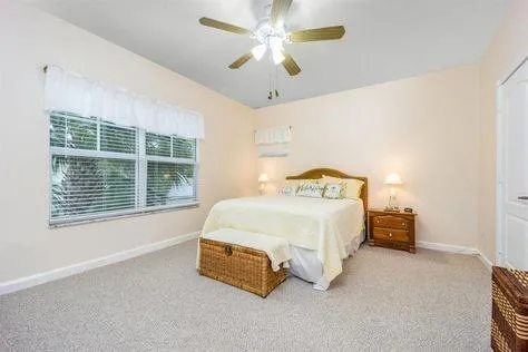 a bedroom with a bed and a chandelier fan