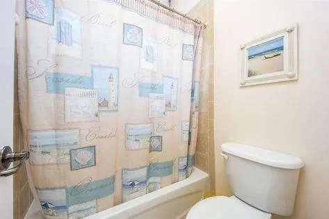 a white toilet sitting next to a bathroom sink