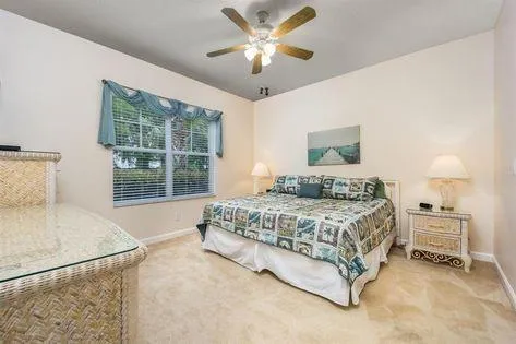 a spacious bedroom with a bed and a large window