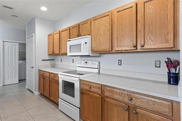 a kitchen with stainless steel appliances granite countertop a sink a stove and cabinets