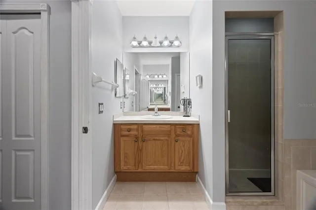 a bathroom with a sink vanity and a mirror