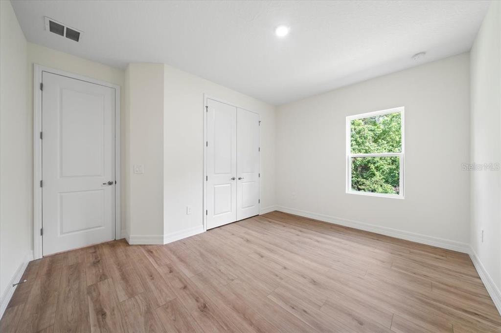 2404 Hanford Lane North Port, FL 34288 - Photo 24 of 26 a view of an empty room with wooden floor and a window