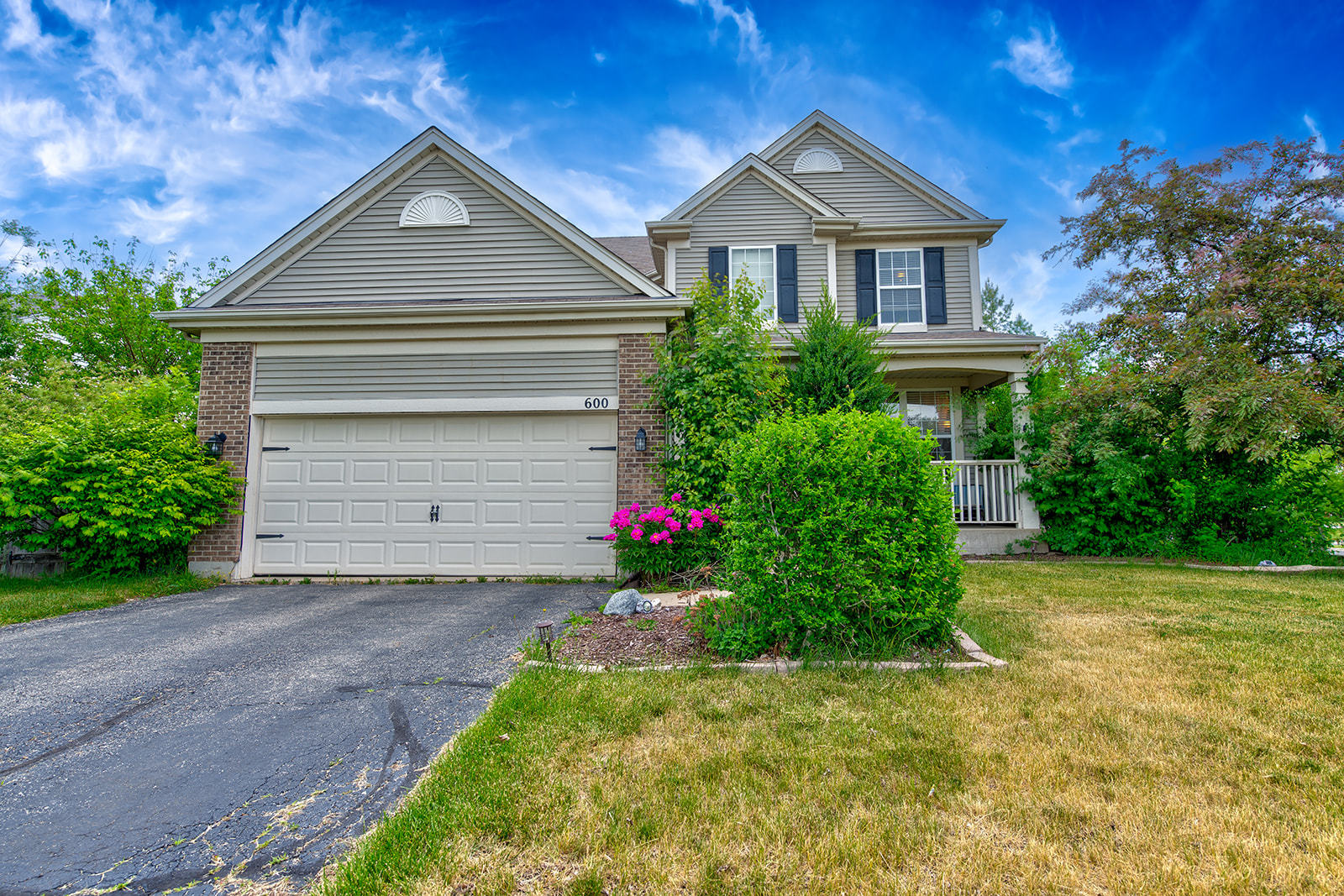 600 Cameron Drive Antioch, IL 60002 - Photo 2 of 23 a front view of a house with a yard and garage