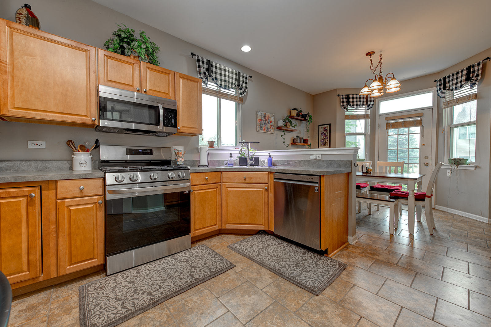 600 Cameron Drive Antioch, IL 60002 - Photo 9 of 23 a kitchen with stainless steel appliances granite countertop a stove top oven a sink dishwasher and white cabinets with wooden floor