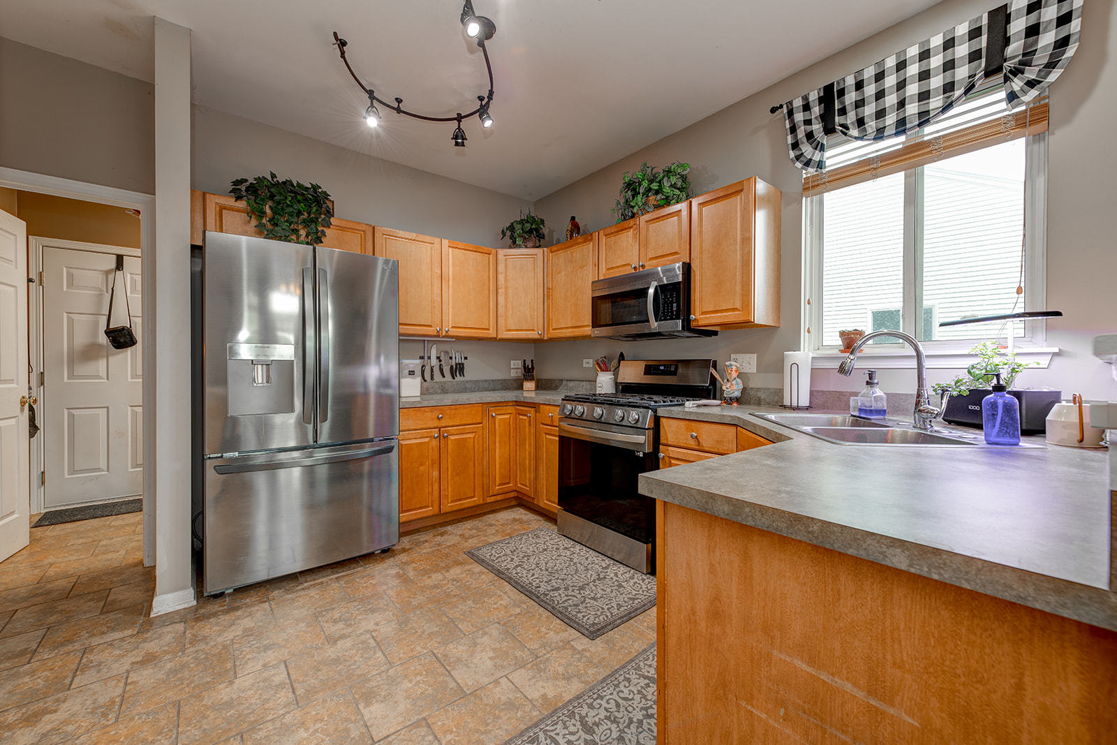 600 Cameron Drive Antioch, IL 60002 - Photo 10 of 23 a kitchen with stainless steel appliances granite countertop a refrigerator a sink a stove and white cabinets
