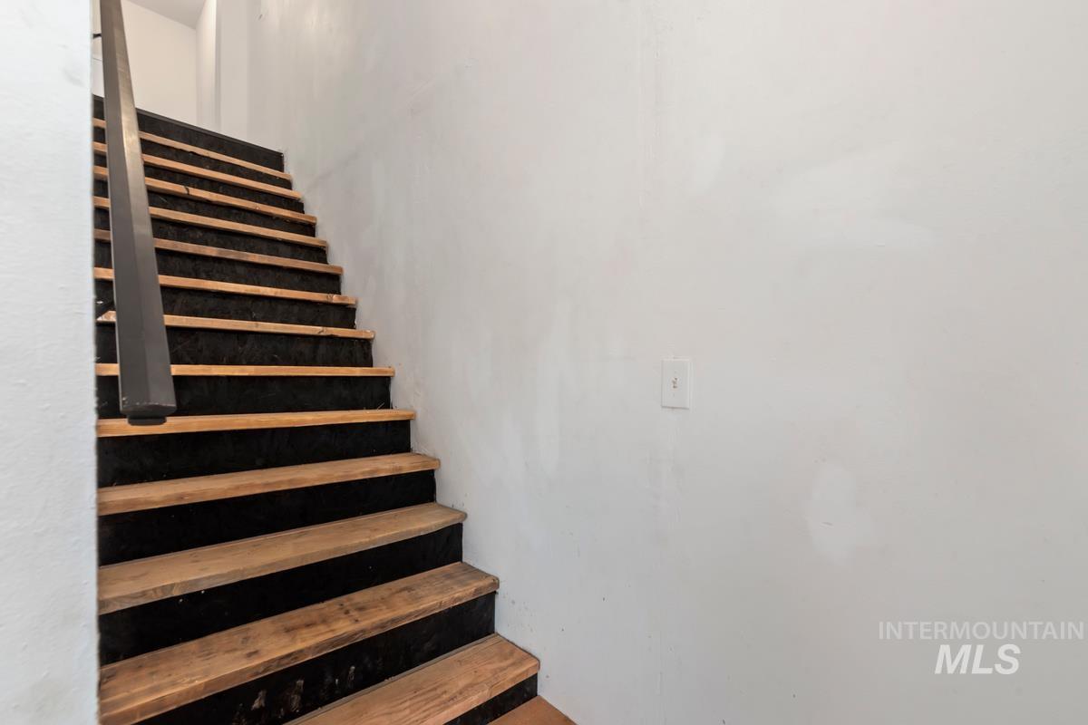 7 Scenic Rim Circle Lowman, ID 83637 - Photo 12 of 35 Staircase featuring wood treads and a dark handrail