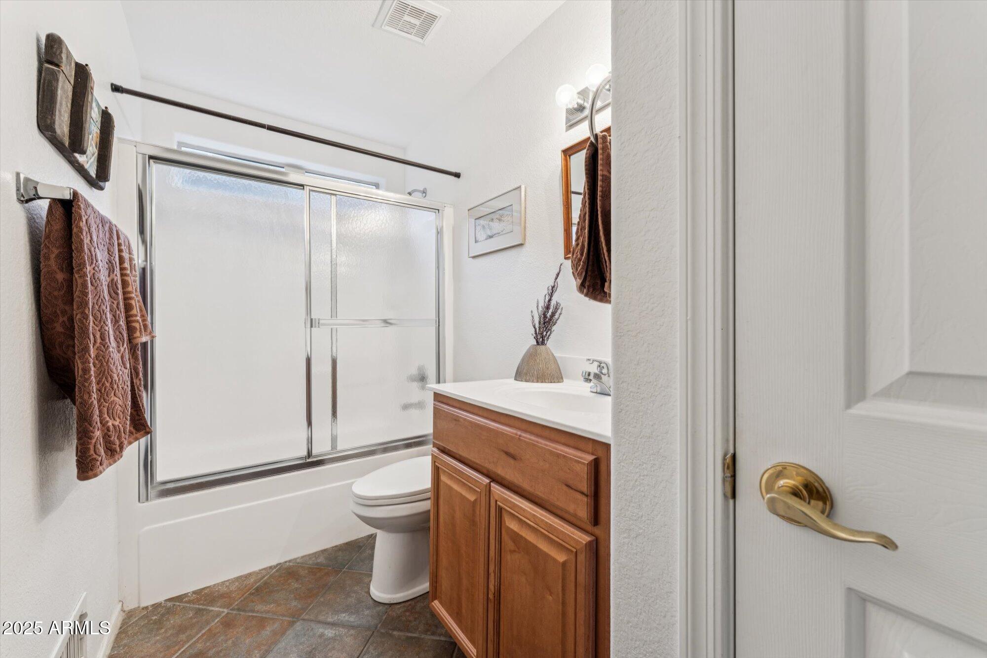 5128 East Via Dona Road Cave Creek, AZ 85331 - Photo 16 of 38 a bathroom with a sink a toilet and shower