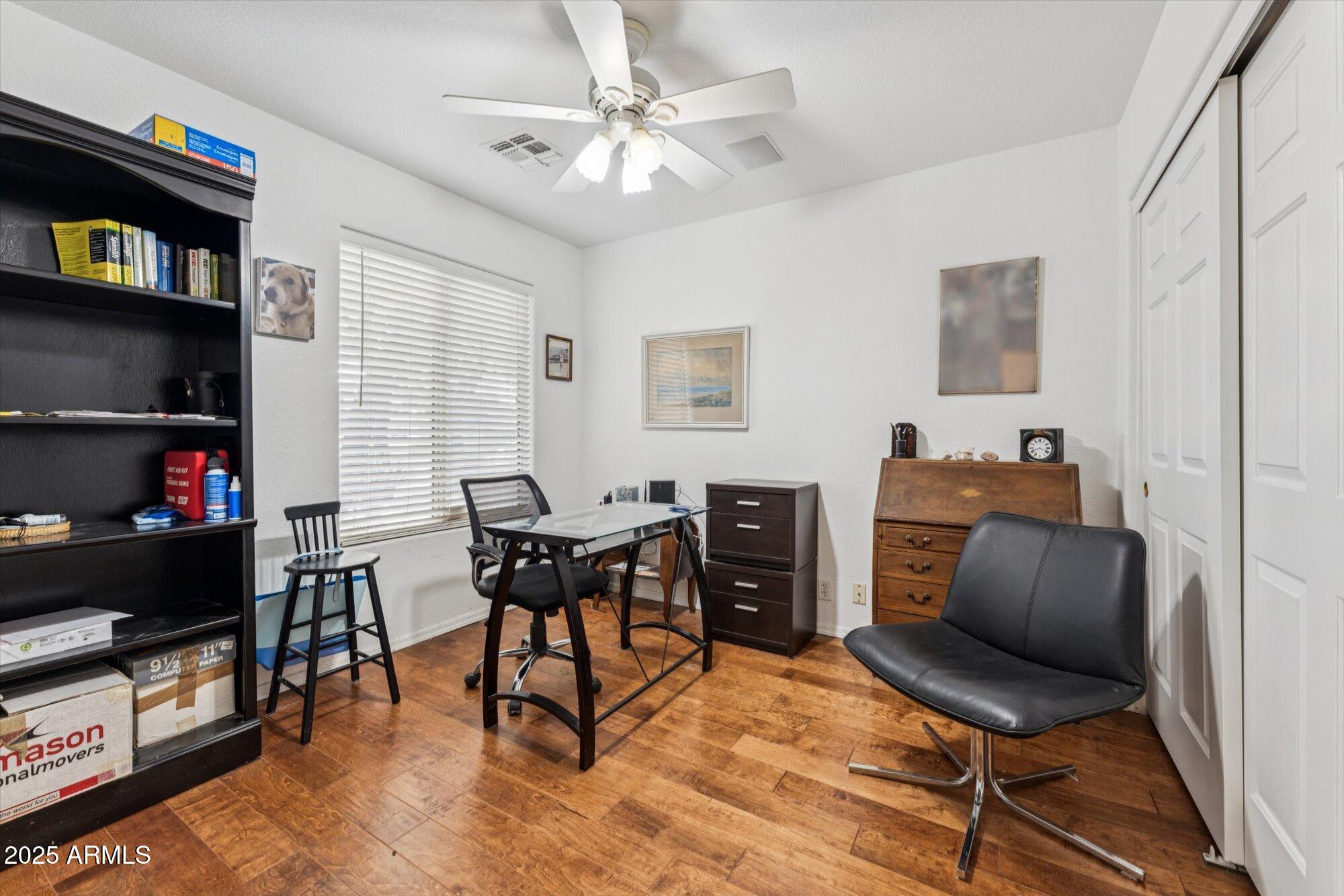 5128 East Via Dona Road Cave Creek, AZ 85331 - Photo 18 of 38 a work room with furniture and a bookshelf