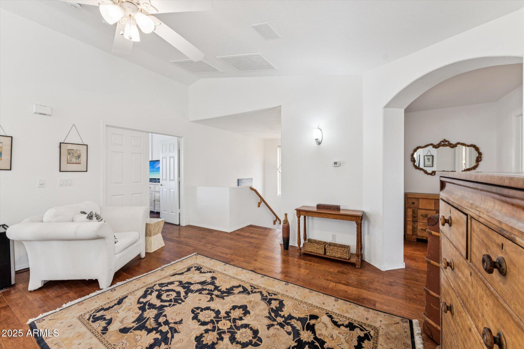 5128 East Via Dona Road Cave Creek, AZ 85331 - Photo 21 of 38 a bedroom with furniture and wooden floor