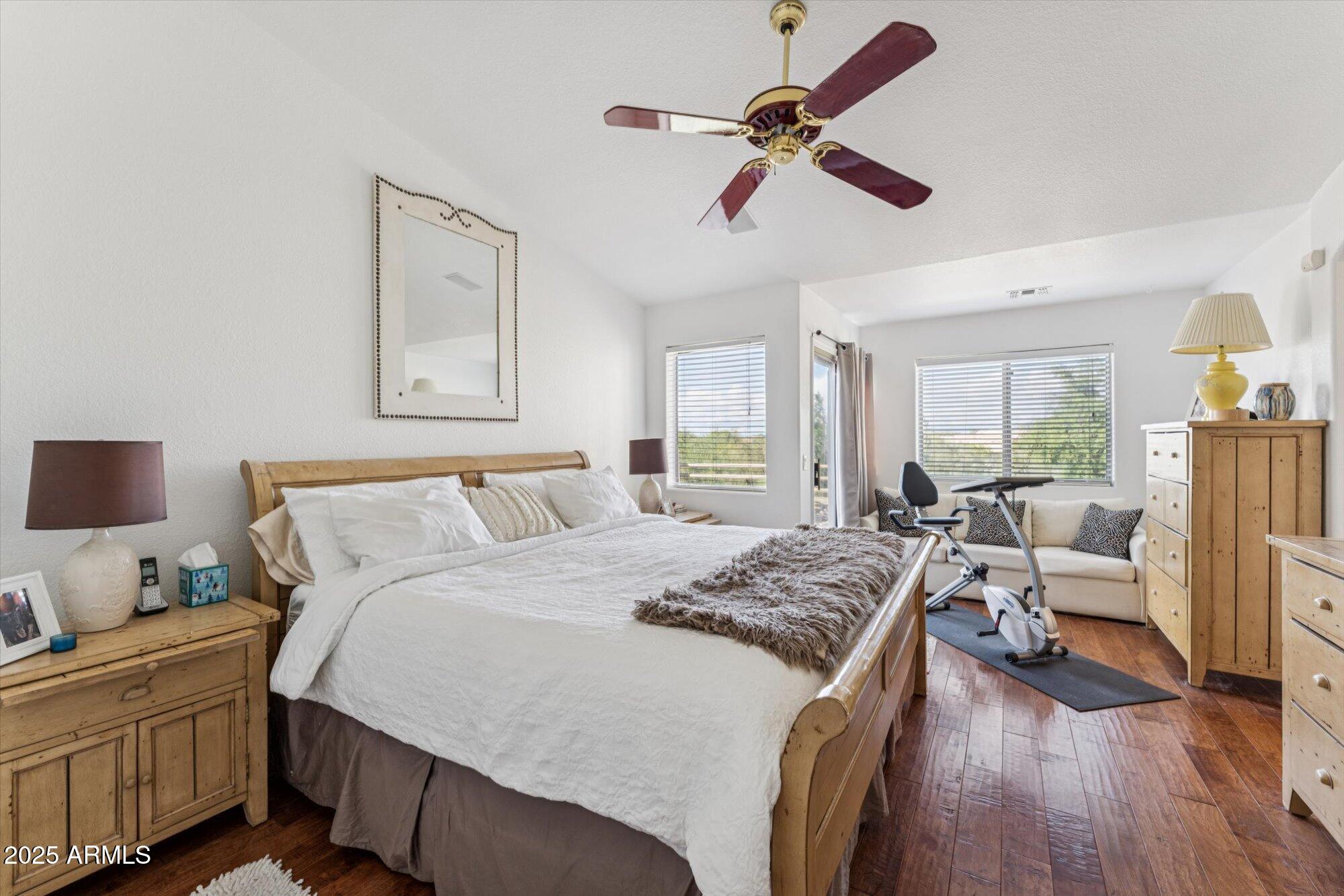 5128 East Via Dona Road Cave Creek, AZ 85331 - Photo 23 of 38 a bedroom with a bed and wooden floor