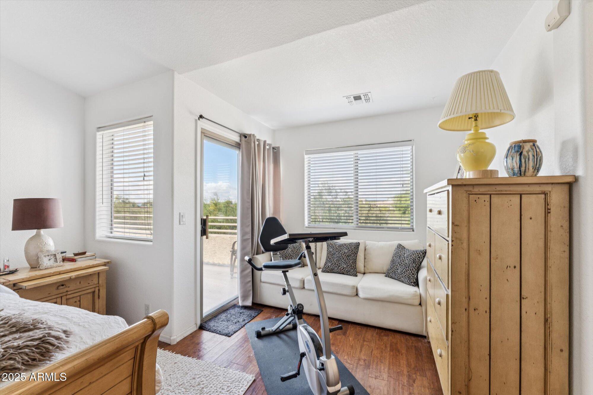 5128 East Via Dona Road Cave Creek, AZ 85331 - Photo 24 of 38 a living room with furniture a window and a flat screen tv