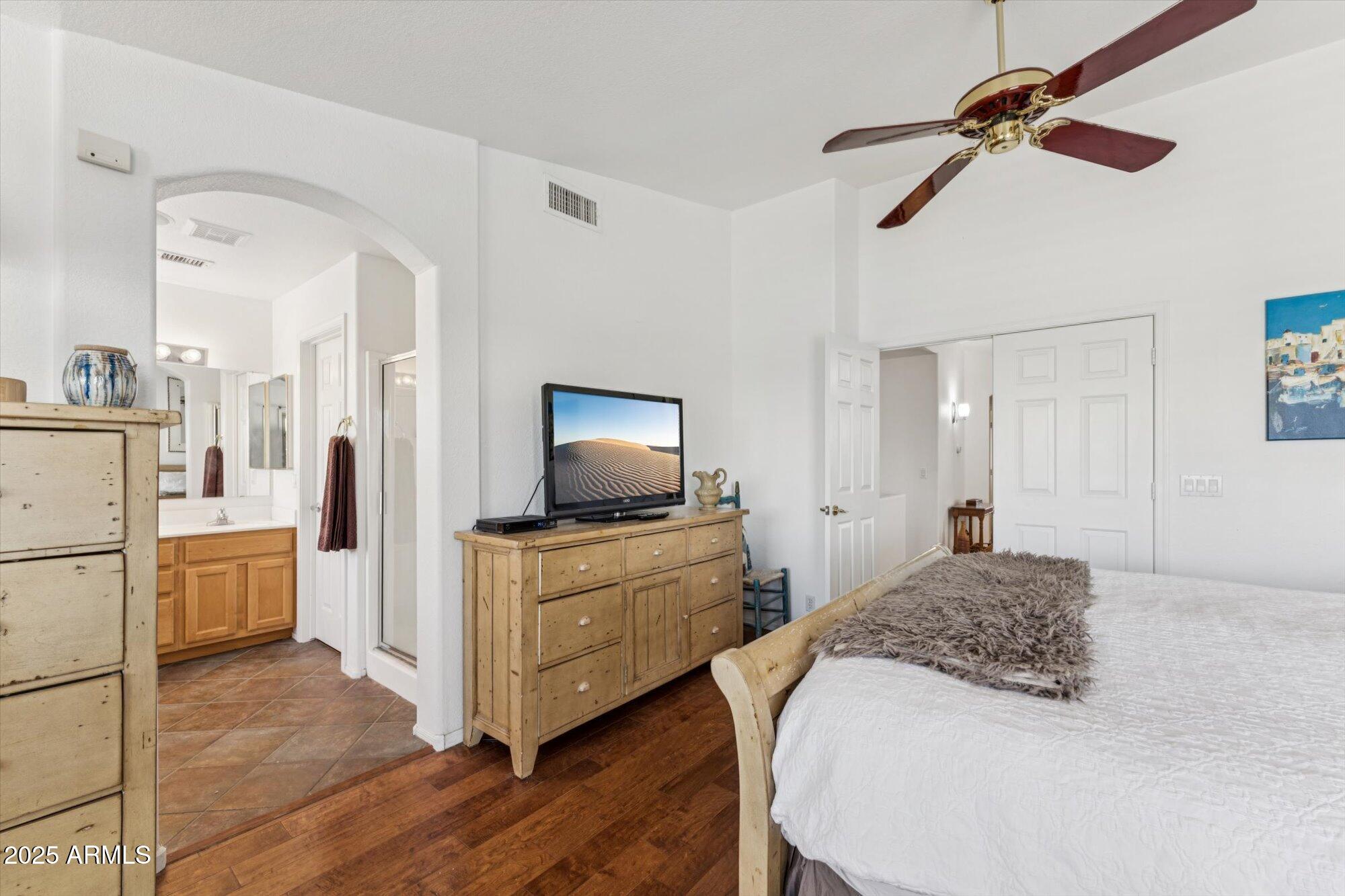 5128 East Via Dona Road Cave Creek, AZ 85331 - Photo 25 of 38 a bedroom with a bed and a flat screen tv