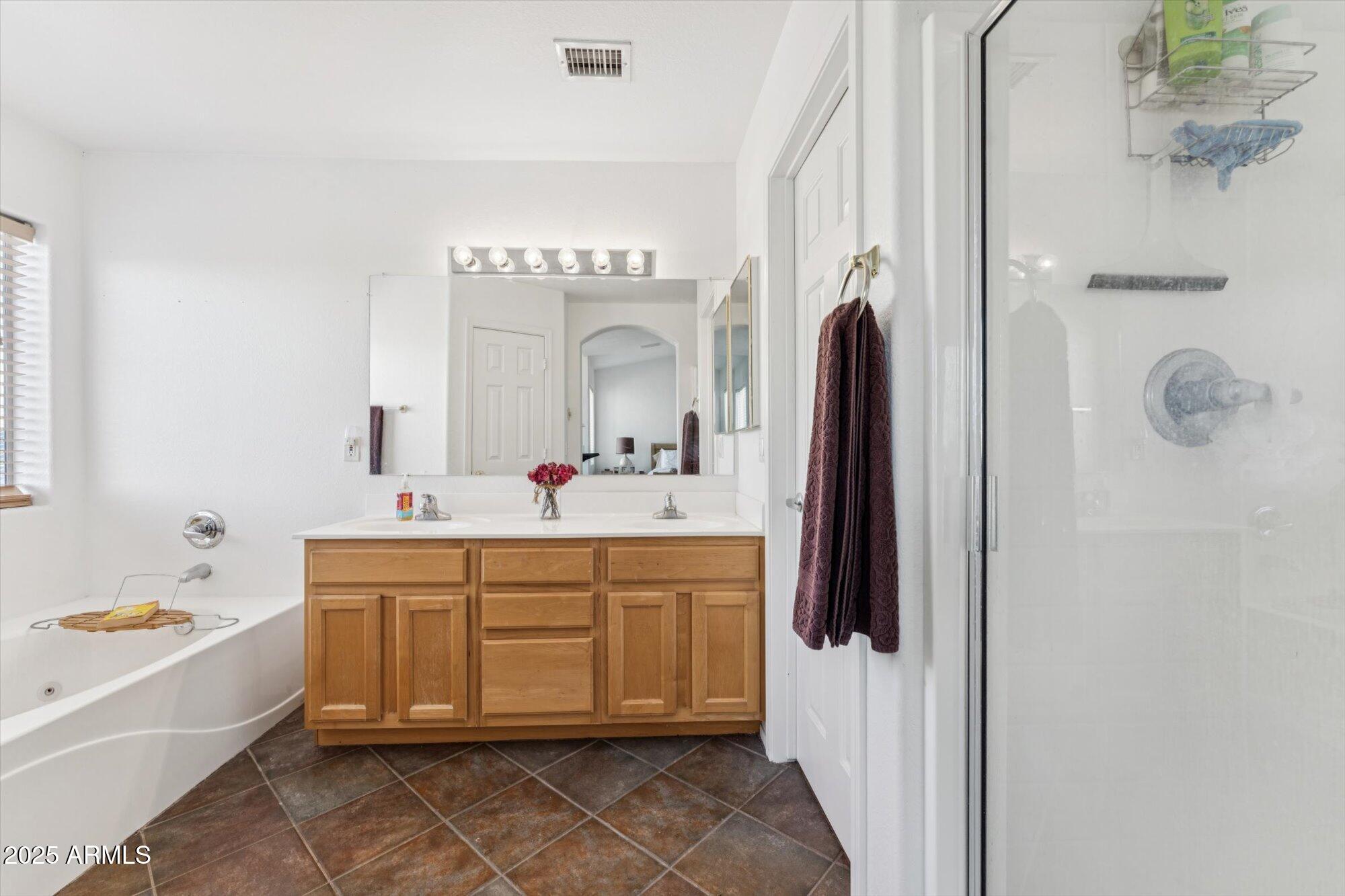 5128 East Via Dona Road Cave Creek, AZ 85331 - Photo 26 of 38 a spacious bathroom with a tub sink and mirror
