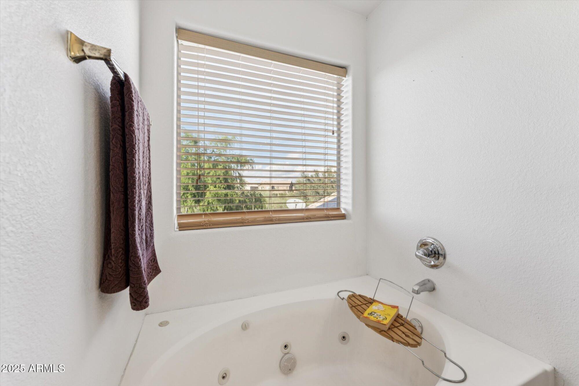 5128 East Via Dona Road Cave Creek, AZ 85331 - Photo 28 of 38 a bath tub sitting in a bathroom next to a window