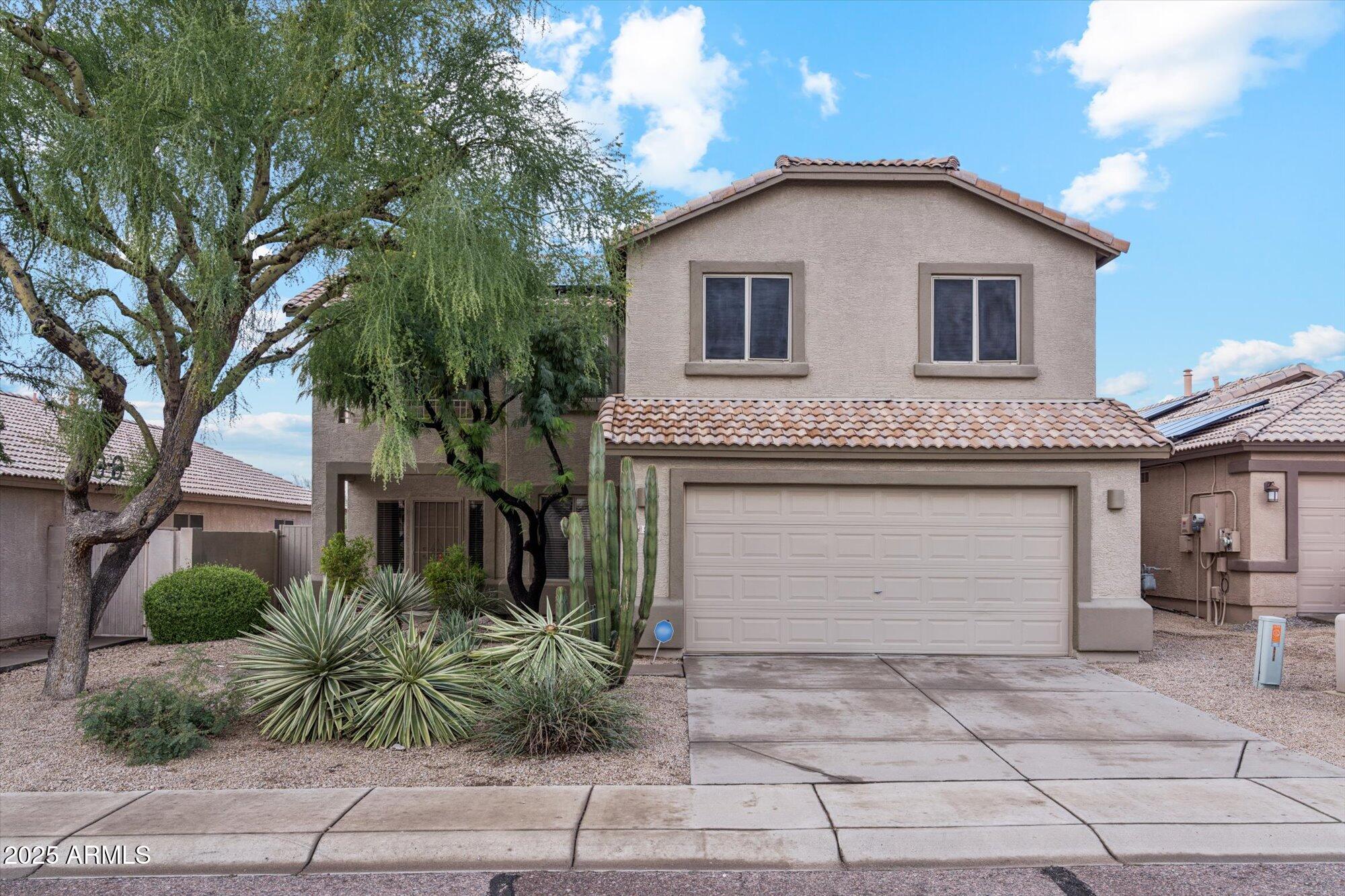 5128 East Via Dona Road Cave Creek, AZ 85331 - Photo 3 of 38 a front view of a house with garden