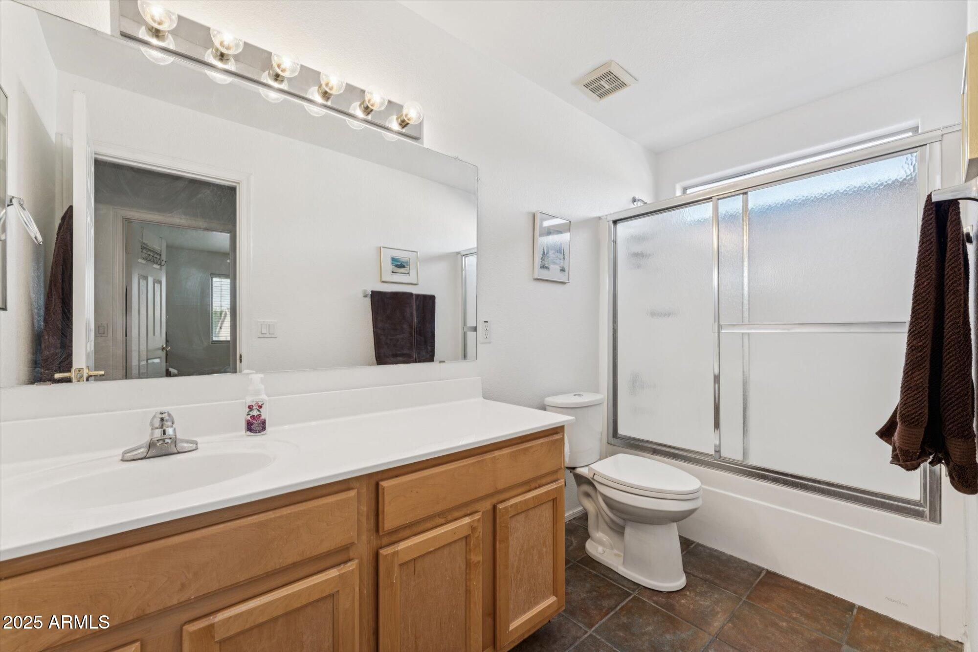 5128 East Via Dona Road Cave Creek, AZ 85331 - Photo 31 of 38 a bathroom with a sink toilet and shower