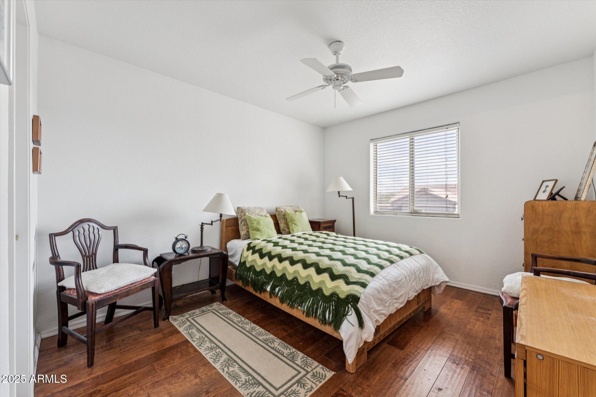 5128 East Via Dona Road Cave Creek, AZ 85331 - Photo 32 of 38 a bedroom with a bed and wooden floor