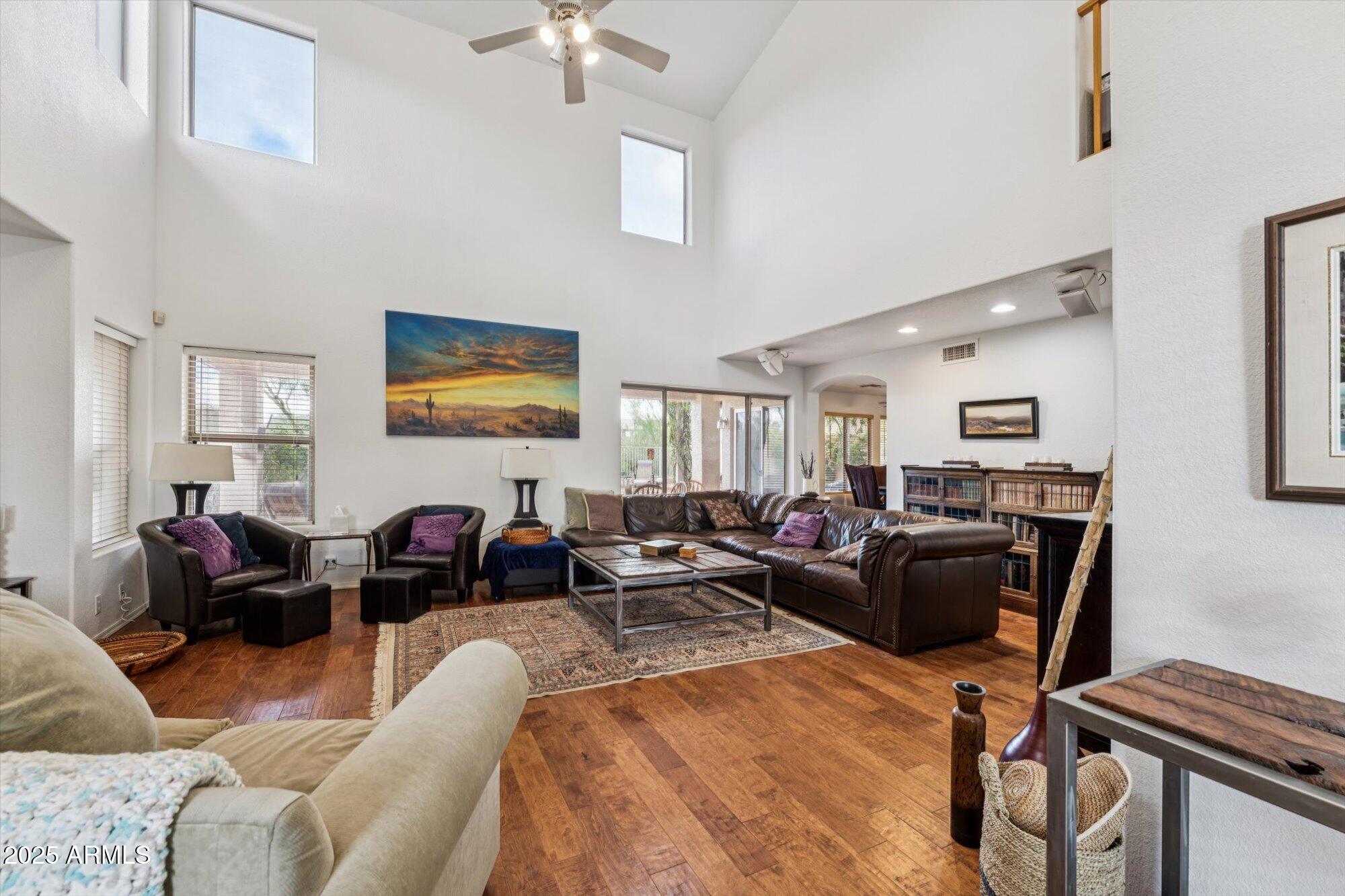 5128 East Via Dona Road Cave Creek, AZ 85331 - Photo 6 of 38 a living room with furniture a ceiling fan and a window