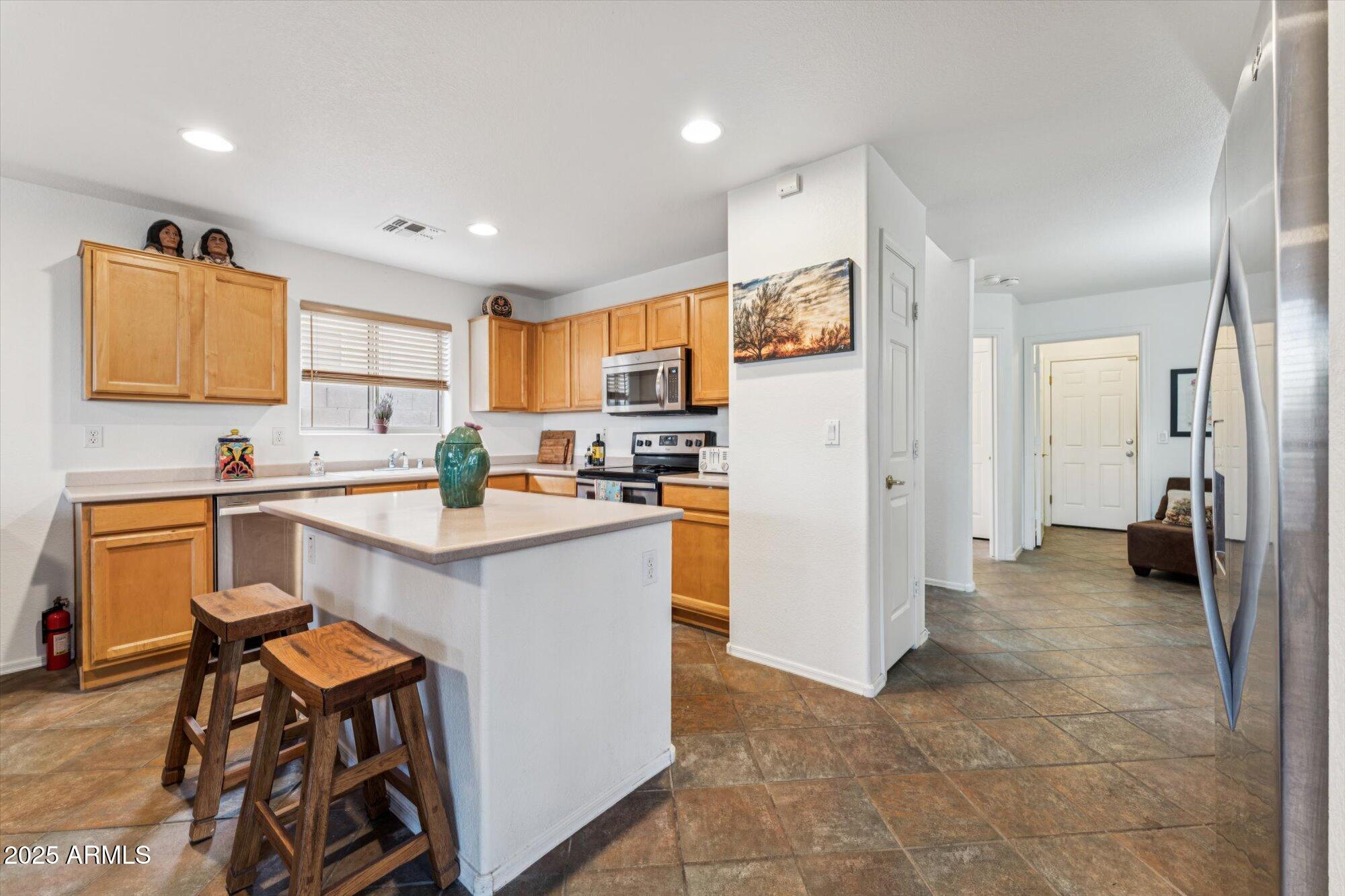 5128 East Via Dona Road Cave Creek, AZ 85331 - Photo 8 of 38 a kitchen with stainless steel appliances granite countertop a refrigerator and a stove top oven