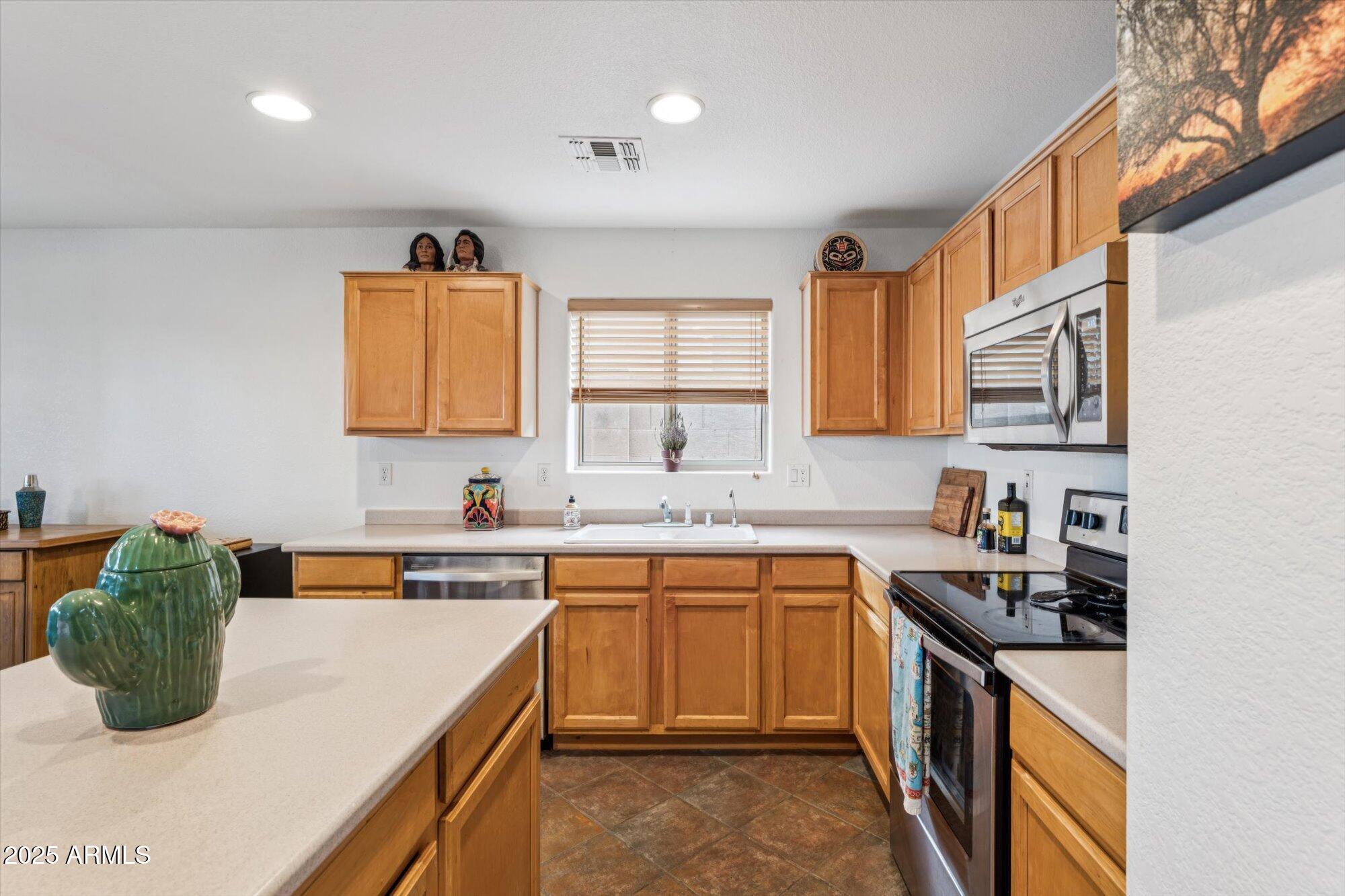 5128 East Via Dona Road Cave Creek, AZ 85331 - Photo 10 of 38 a kitchen with a sink a stove and cabinets