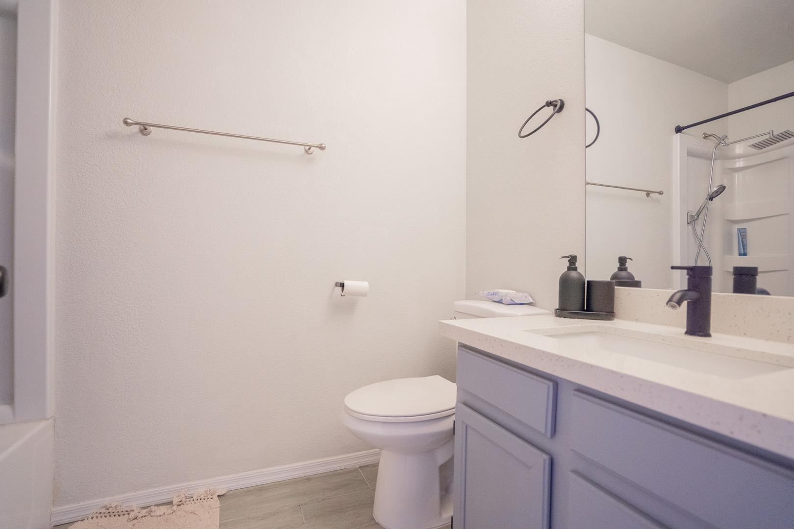 8111 West Wacker Road, Unit 70 Peoria, AZ 85381 - Photo 20 of 38 a bathroom with a granite countertop sink toilet and shower