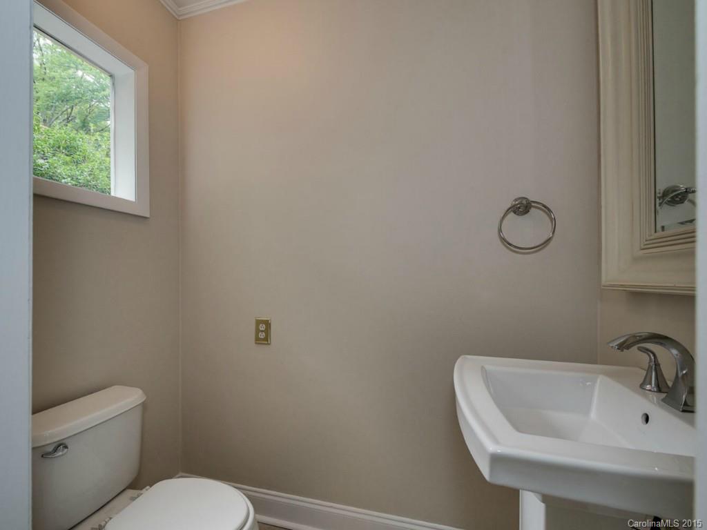 907 Sedgefield Road Charlotte, NC 28209 - Photo 13 of 21 a bathroom with a toilet sink and mirror