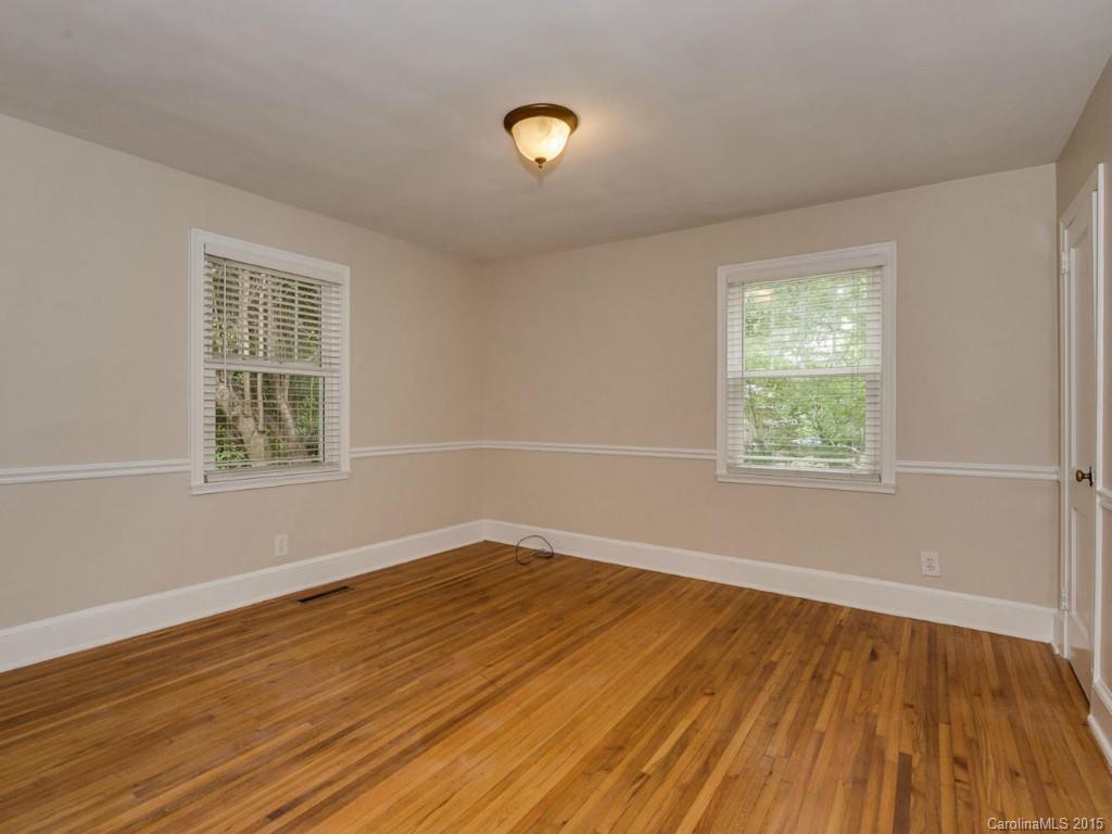 907 Sedgefield Road Charlotte, NC 28209 - Photo 14 of 21 a view of an empty room with wooden floor and a window
