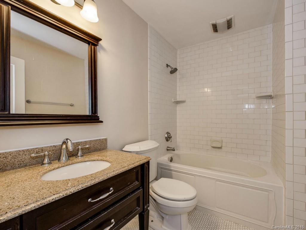 907 Sedgefield Road Charlotte, NC 28209 - Photo 15 of 21 a bathroom with a granite countertop sink toilet and a mirror