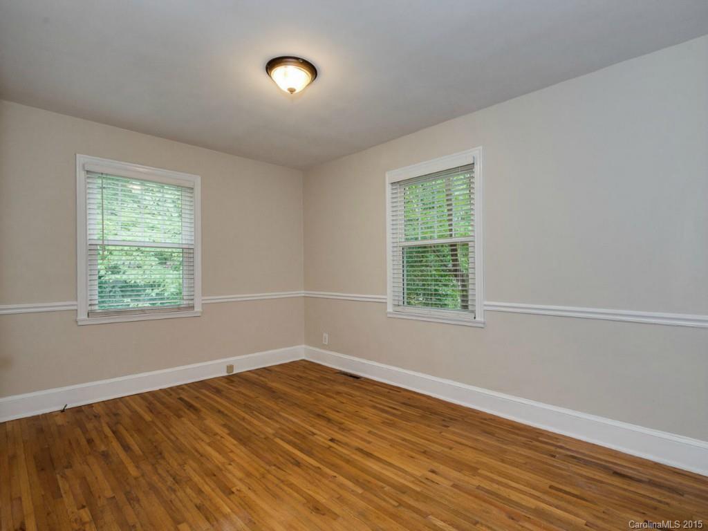 907 Sedgefield Road Charlotte, NC 28209 - Photo 16 of 21 a view of empty room with wooden floor and fan