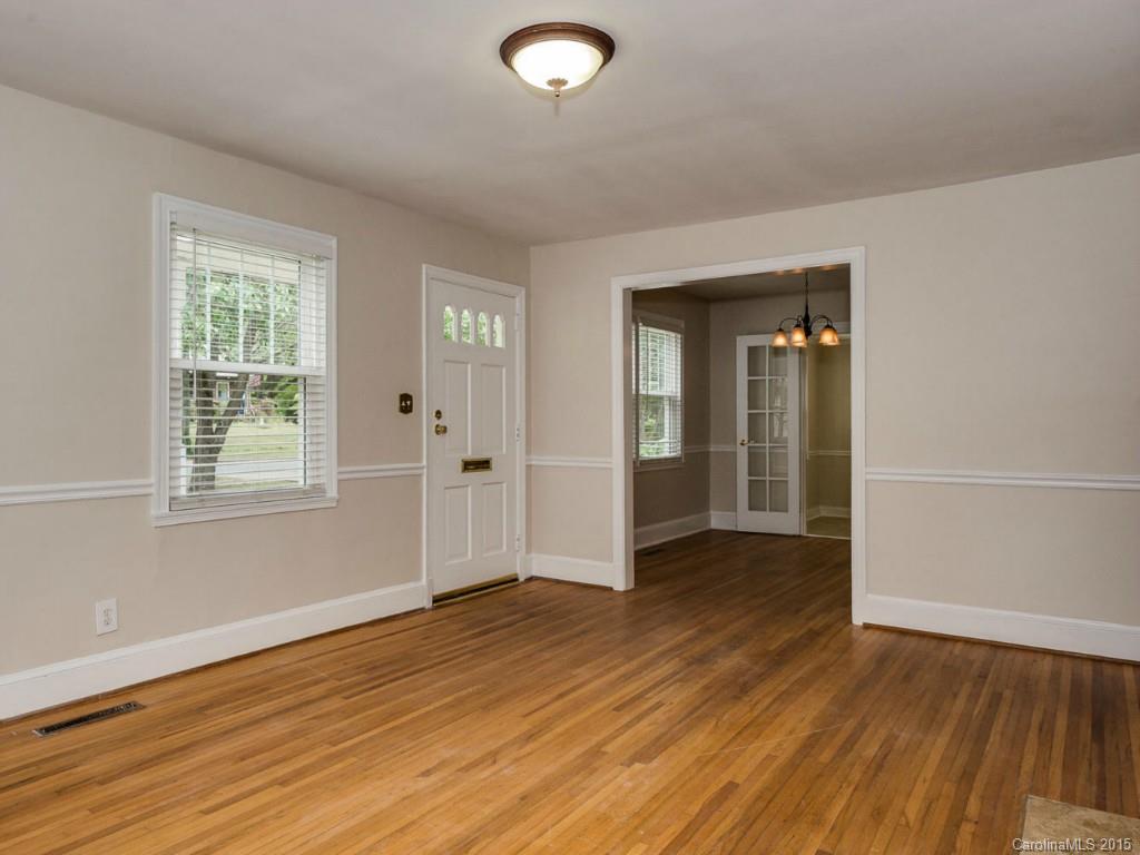907 Sedgefield Road Charlotte, NC 28209 - Photo 5 of 21 an empty room with wooden floor and windows