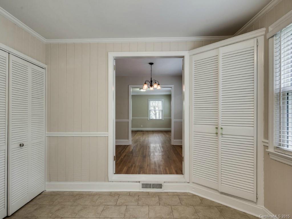 907 Sedgefield Road Charlotte, NC 28209 - Photo 7 of 21 a view of a hallway with wooden walls and a window