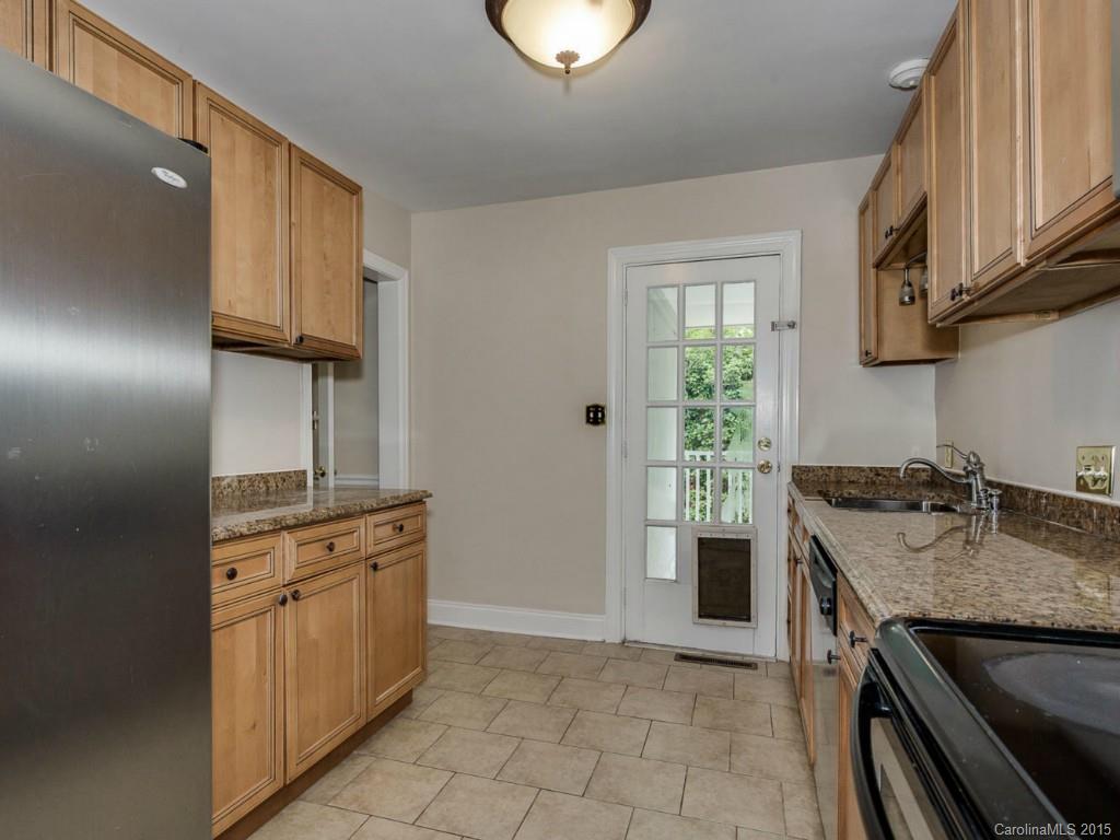 907 Sedgefield Road Charlotte, NC 28209 - Photo 9 of 21 a kitchen with granite countertop a sink stove and cabinets