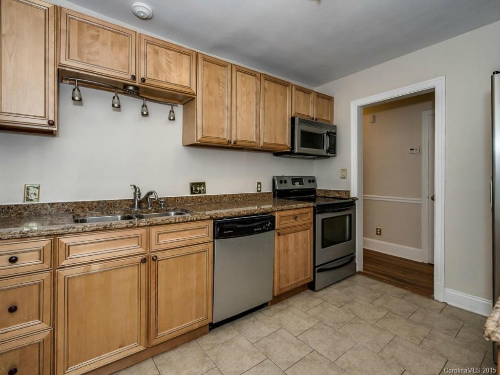 907 Sedgefield Road Charlotte, NC 28209 - Photo 10 of 21 a kitchen with stainless steel appliances granite countertop a refrigerator and a stove top oven