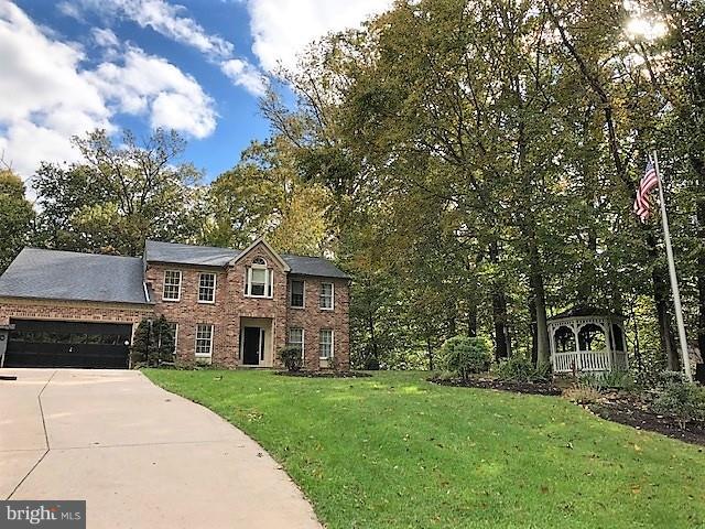 1217 Brookview Road Baltimore, MD 21286 - Photo 2 of 16 a front view of a house with a garden and trees